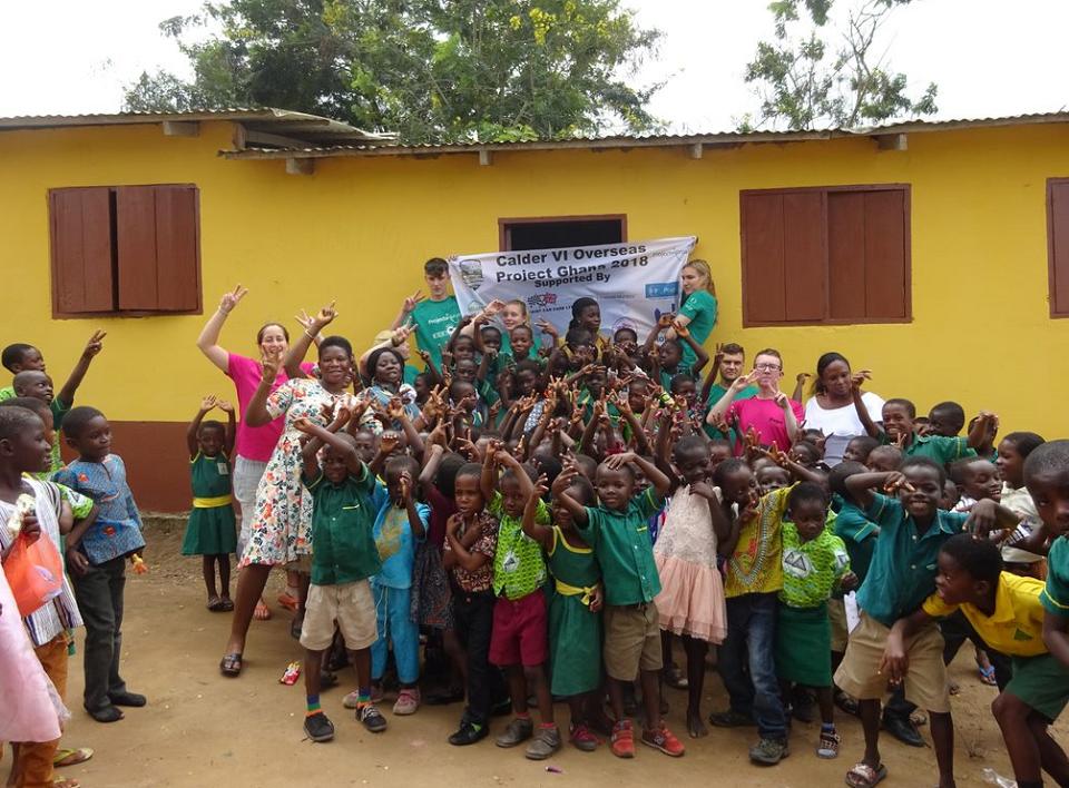 School children and volunteers pose with their banner School children and volunteers
