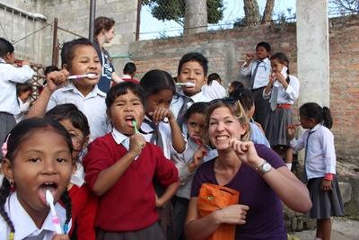 UK volunteer Nepal hygiene workshop A female UK volunteer teaches Nepalese children about hygiene