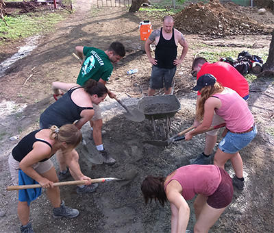 SmithCorp volunteers mixing cement Volunteers working at their Building Project